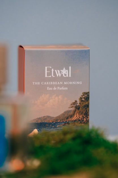 The Caribbean Morning perfume bottle displayed on a wood pedestal